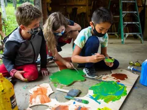 a group of children painting