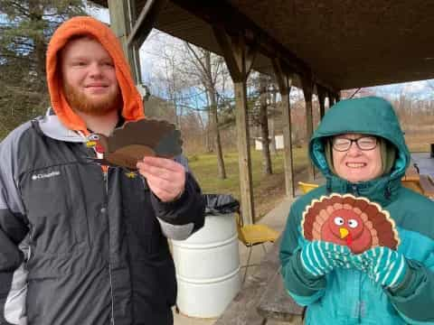 a man and a woman holding a bird