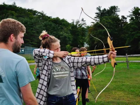 a group of people holding a bow and arrow
