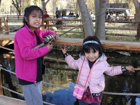 a couple of girls holding a fish