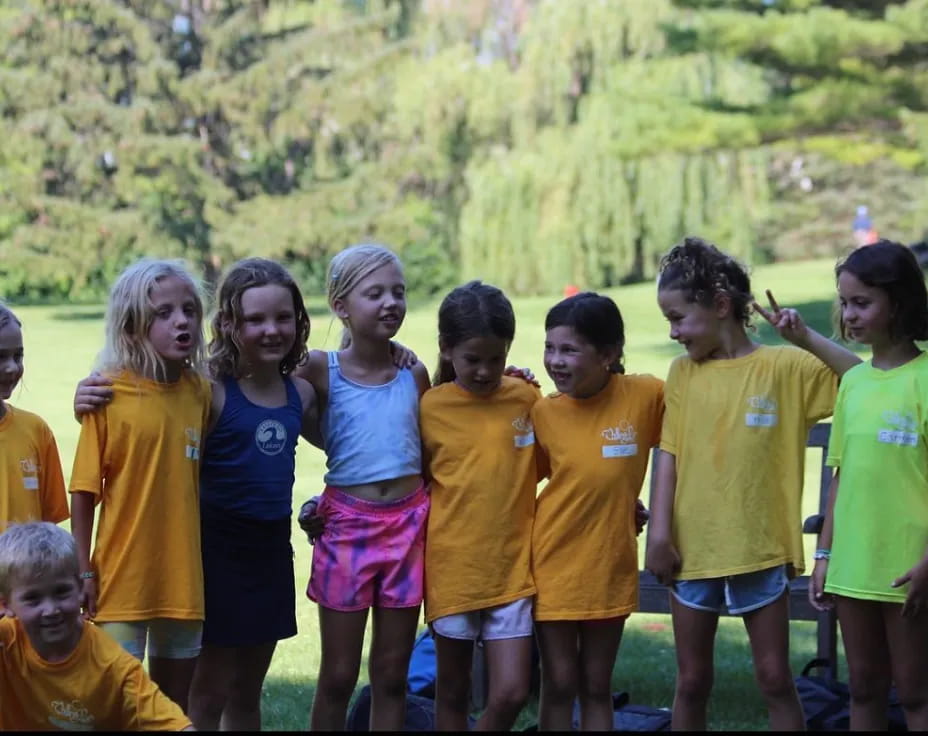 a group of children in yellow shirts