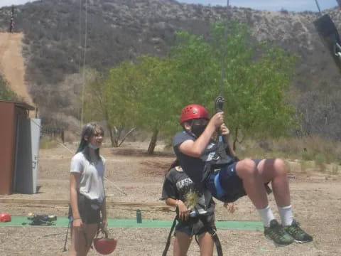 a man holding a bow and arrow next to a woman holding a bow and arrow