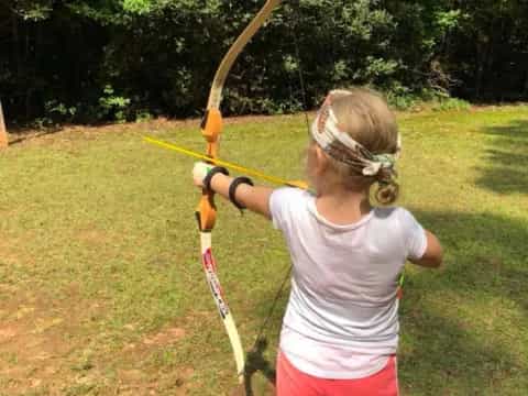 a girl shooting a bow