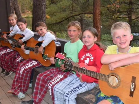 a group of kids holding guitars