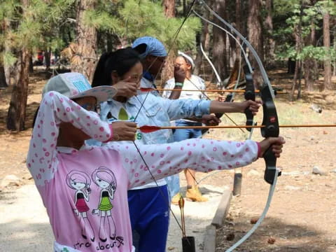 a group of people shooting bows