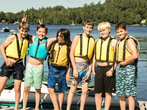 a group of people wearing life vests posing for a photo