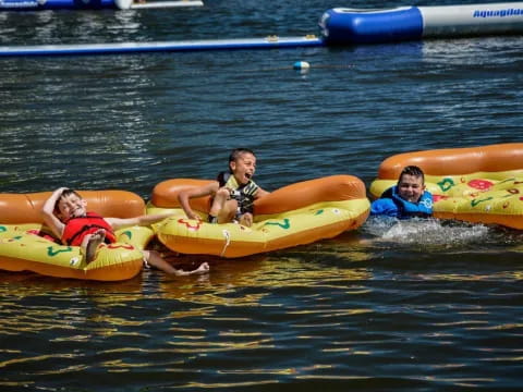 a group of people on inner tubes in the water