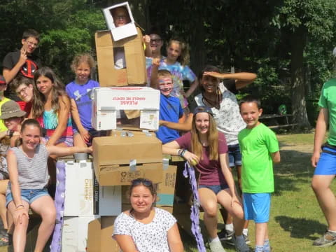 a group of people posing for a photo with boxes on their heads