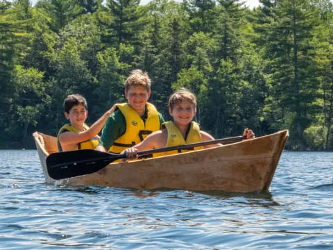 a group of boys in a canoe