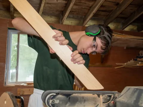 a person holding a large wooden object