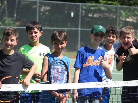 a group of boys holding tennis rackets