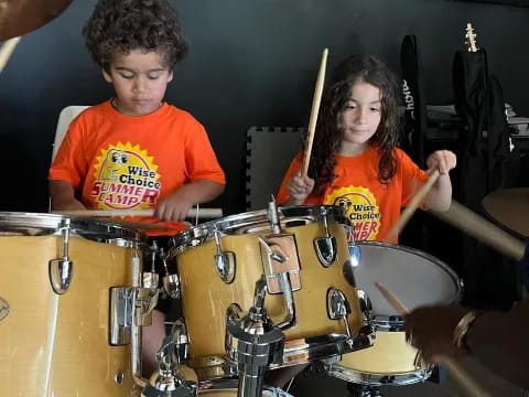 a couple of kids playing drums