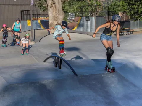a group of women rollerblading at a skate park