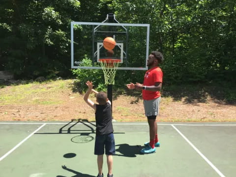 a couple of boys playing basketball