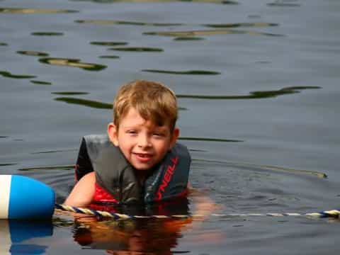 a boy playing with a frisbee in the water