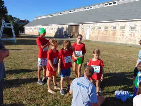 a group of children in red shirts