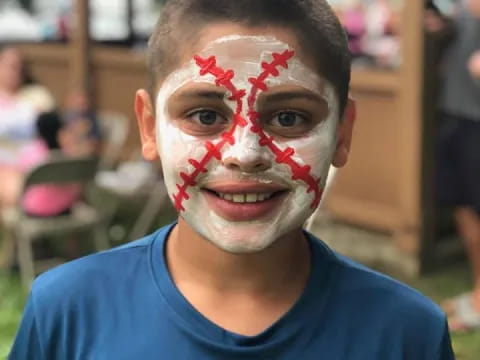 a person with red and white paint on the face