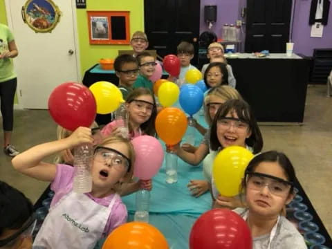 a group of children holding balloons