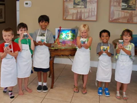 a group of children holding small cups