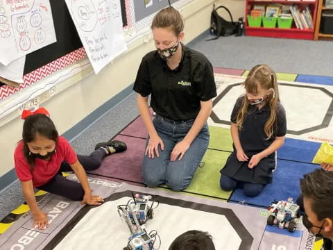 a person and a group of kids playing with toys