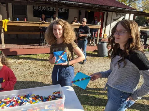 a couple of girls holding a gift box