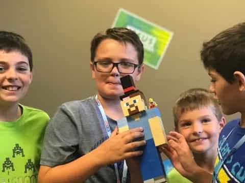 a group of boys holding a toy