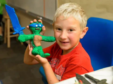 a boy holding a toy