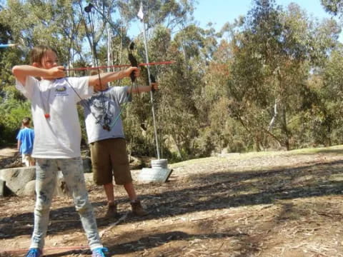 a couple of people shooting bows