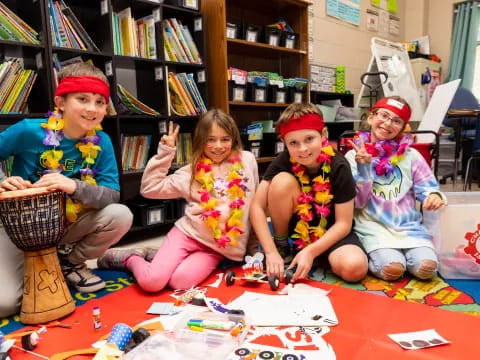 a group of children sitting on the floor in front of a bookcase