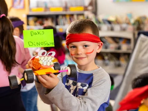 a boy holding a toy