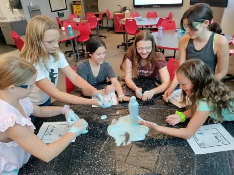 a group of women doing a science experiment