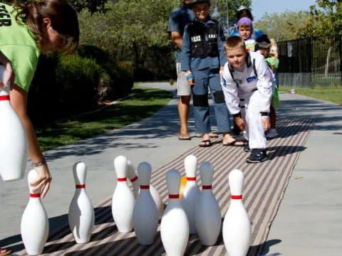 a group of people looking at a group of white bottles