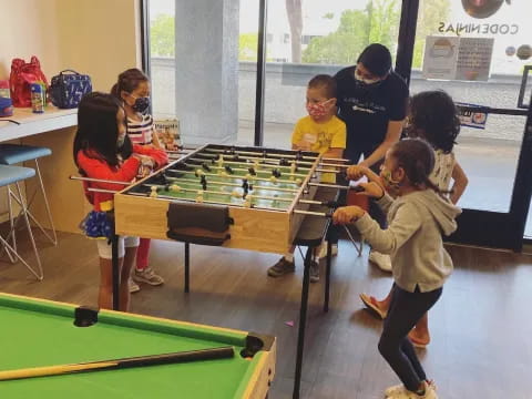 a group of people playing foosball