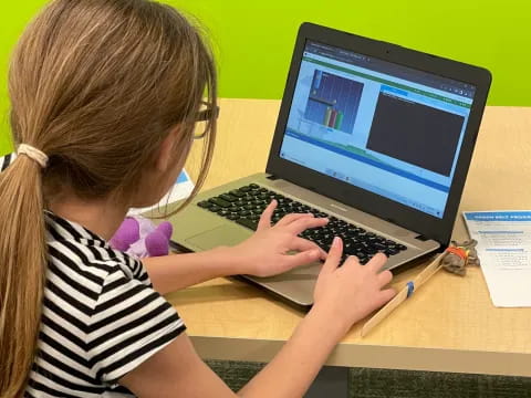 a young girl using a laptop