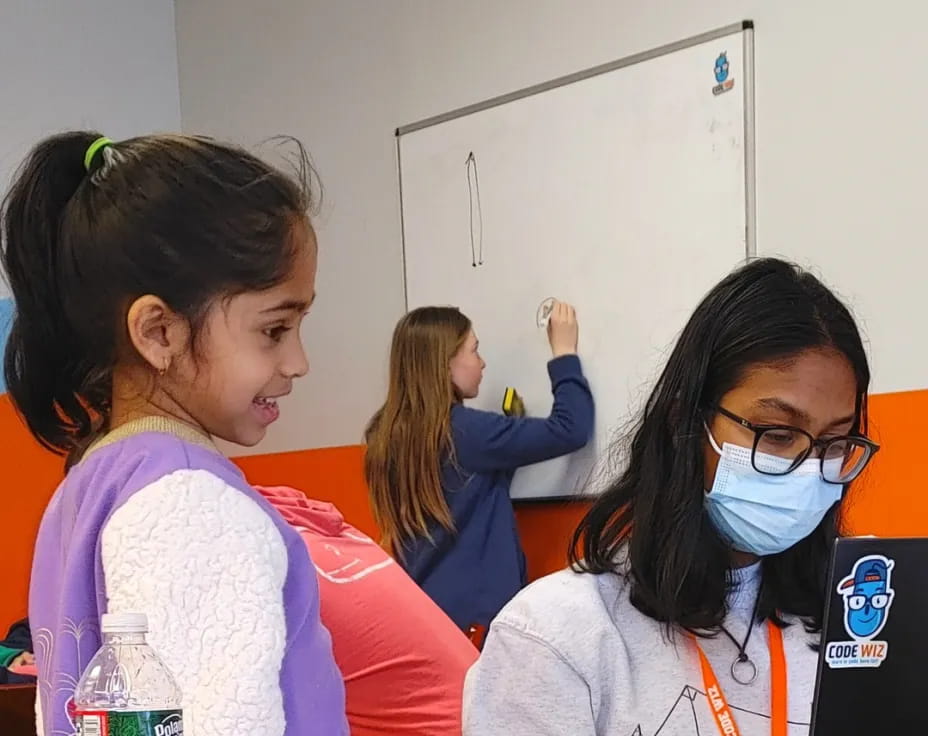 a few young girls in a classroom