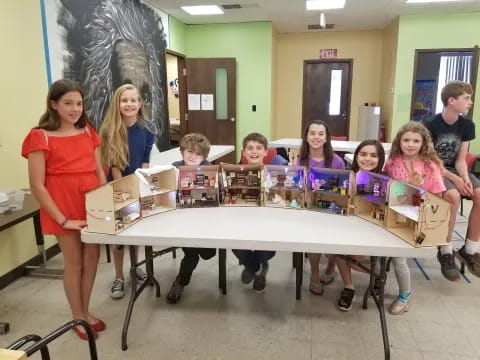 a group of children holding boxes