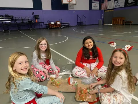 a group of girls sitting on the floor with toys