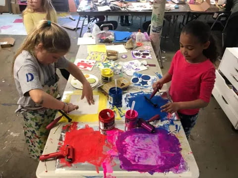 a few young children painting