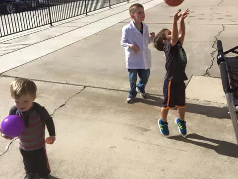 a group of children playing basketball