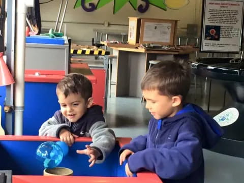 two boys sitting at a table