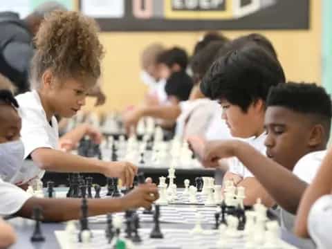 a group of children playing chess
