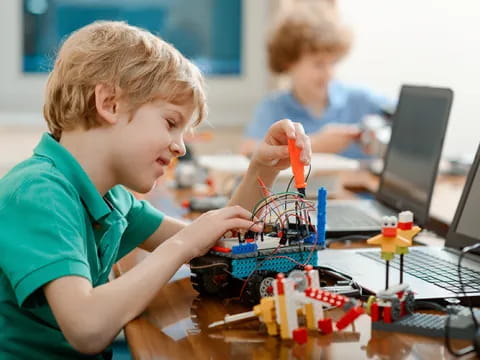 a young boy working on a computer