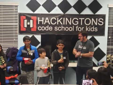 a group of people standing in front of a sign