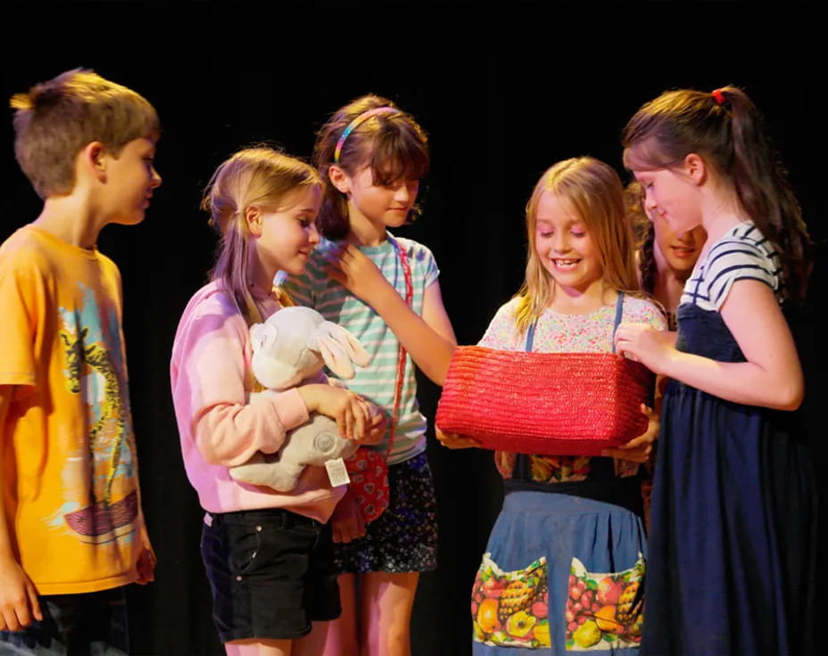 a group of children holding a stuffed animal