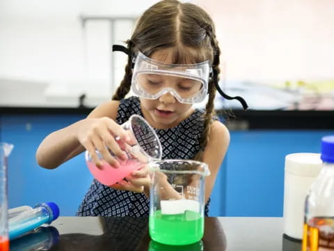 a girl wearing a mask and holding a beaker