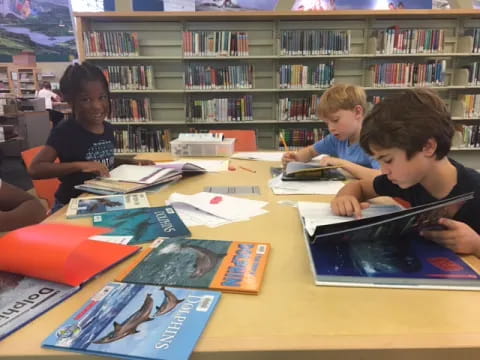 a group of kids studying in a library