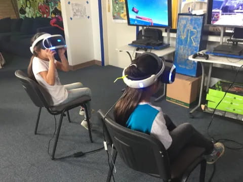 a couple of women wearing vr goggles