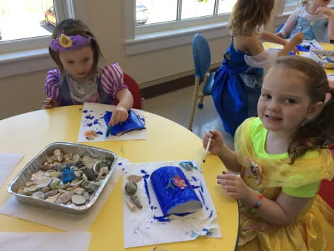 a group of children painting