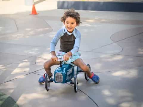 a child riding a tricycle