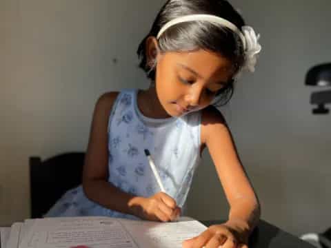 a young girl reading a book